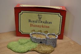 A Royal Doulton Bunnykins 'Robin Hood Collection' castle form display stand, with original