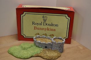 A Royal Doulton Bunnykins 'Robin Hood Collection' castle form display stand, with original