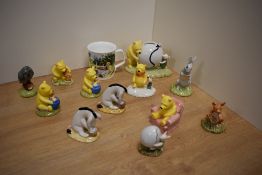 A collection of twelve Royal Doulton bone china 'Winnie The Pooh Collection' figures, comprising two