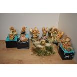 A collection of eleven Pendelfin hand-painted stoneware anthropomorphic rabbit figures and stands,
