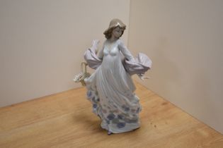 A Lladro porcelain 'Spring Splendor' figurine, number 5898, modelled as a young woman in flowing