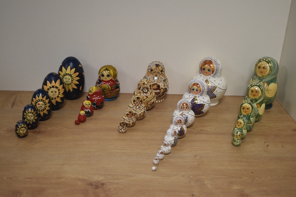 A group of six Russian hand-decorated Matryoshka dolls, of traditional form, one with white jewelled