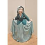 A German Art Deco Katzhutte Porcelain figurine, depicting gril in flowing green dress, printed