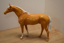 A large Beswick Pottery Large Racehorse, number 1564, designed by Arthur Gredington in palomino