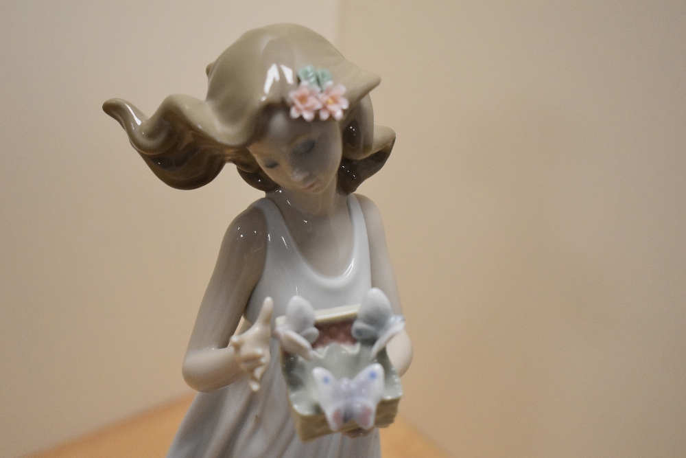 A Lladro porcelain 'Butterfly Treasures' figurine, number 6777, modelled as a young girl in - Image 2 of 3