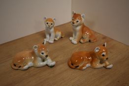 A group of four USSR Russian Lomonosov porcelain animal figures, four lion cubs, two laying, two