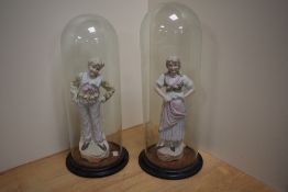A pair of 19th century German bisque porcelain figures depicting typical male and female fisgures