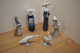 A group of six Lladro porcelain figurines and bird studies, comprising two nun figurines 5550 &