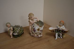 A group of three 19th century Continental porcelain figural vases, each modelled with young child or