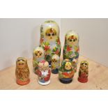 A group of five Russian hand-decorated Matryoshka dolls, of traditional form, one poker worked and