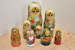 A group of five Russian hand-decorated Matryoshka dolls, of traditional form, one poker worked and