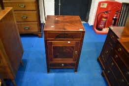An Edwardian style mahogany cupboard having hinged top and open back