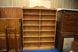 A modern pine bookshelf, approx. dimensions H200cm W153cm D26cm