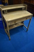 A limed oak desk or dressing table in the Arts and Crafts style, dimensions approx. W83 H90 D47cm
