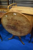 A 19th Century oak snaptop occasional table having circular top, turned column and triple splay