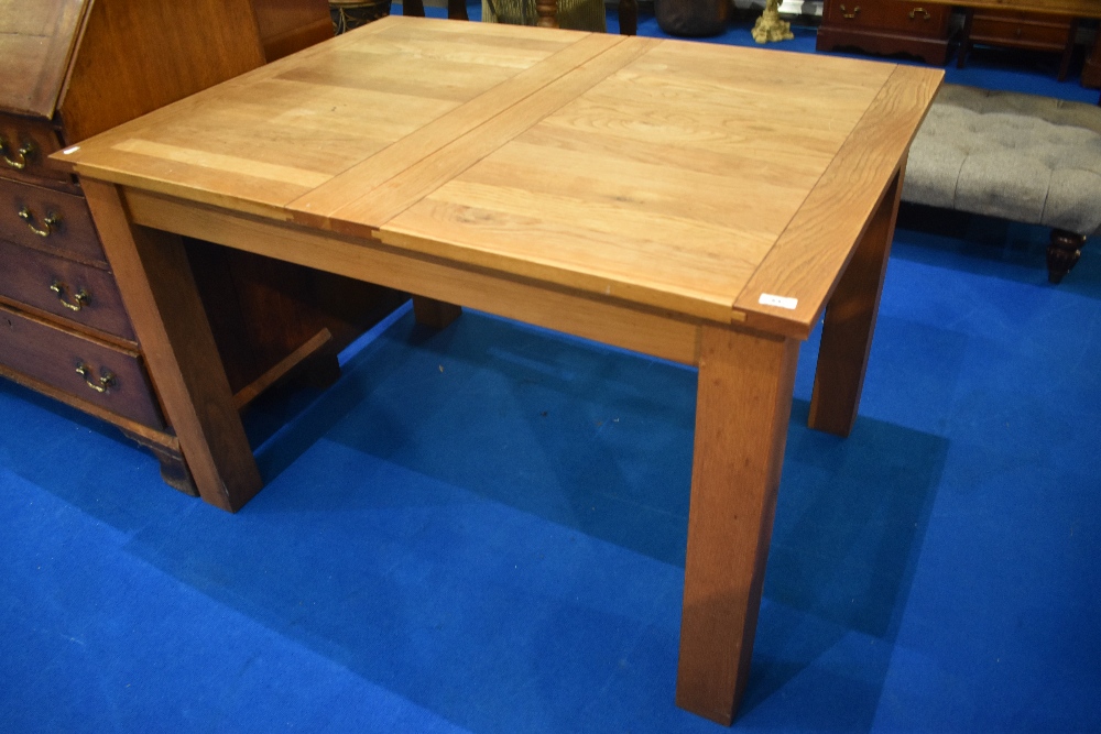 A modern oak extending dining table , approx. 120 x 90cm, extending to 180cm