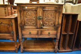 A carved Titchmarsh and Goodwin oak Tv cabinet / side cabinet, W 84cm, D 45, H 100cm.