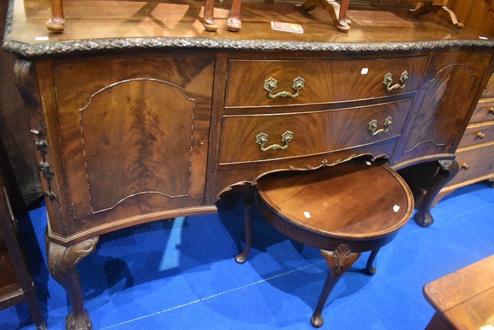 An early 20th Century mahogany sideboard having ledge back and carved border, width approx. 180cm