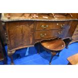 An early 20th Century mahogany sideboard having ledge back and carved border, width approx. 180cm