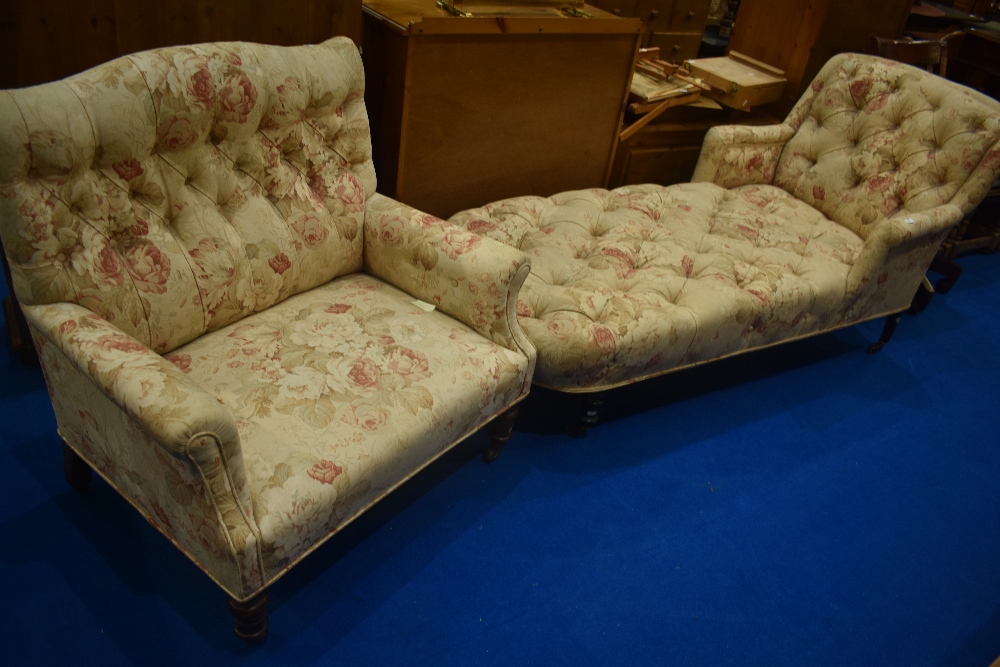 A Victorian day bed and wide armchair, both having turned mahogany legs and floral upholstery ,