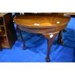 An early to mid 20th Century coffee table having circular top and cabriole legs having ball and claw