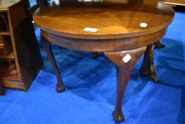 An early to mid 20th Century coffee table having circular top and cabriole legs having ball and claw