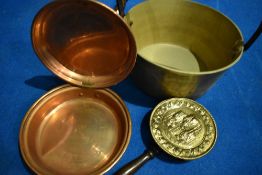 A traditional brass jam pan and two decorative warming pans