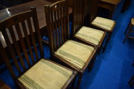 A set of four early 20th Century oak rail back dining chairs