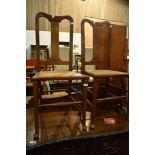 A pair of stained frame bedroom chairs having bergere cane seats