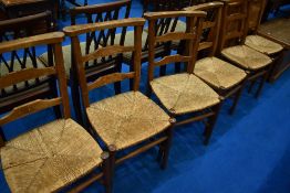 A set of six rush seated chapel chairs having ladder backs