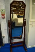A reproduction mahogany framed cheval mirror having turned supports