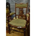 A late Victorian/Edwardian mahogany salon armchair having inlaid decoration to back, upholstered