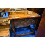 A traditional oak storage table of small proportions