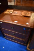 A modern reproduction Regency mahogany effect chest of three bedroom drawers and an adjustable