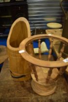 A decorative wooden churn and stand