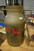 A vintage aluminium churn having painted decoration