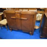 A 1930s oak sideboard having cocktail section to end panel and fitted interior , dimensions approx