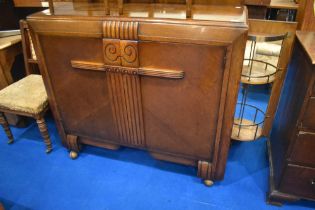 A 1930s oak sideboard having cocktail section to end panel and fitted interior , dimensions approx