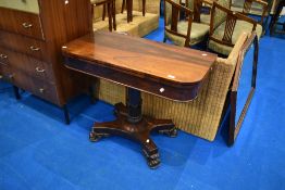 A 19th Century rosewood fold over card table , on tulip column and quatrefoil base, William IV