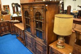A Titchmarsh and Goodwin oak Elizabethan style library book case, approx W 120cm, D 37cm, H 167cm.