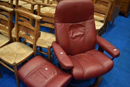 A stressless recliner chair and footstool, in burgundy