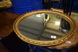 A gilt frame oval wall mirror, approx. 57 x 46cm