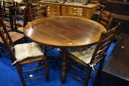 A Titchmarsh and Goodwin dining suite compriising circular table (diameter 122cm) and four ladder
