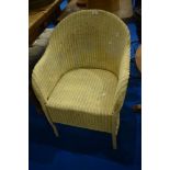 A vintage Lloyd Loom tub chair, in cream