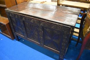 An 18th Century dark oak 3 panel coffer having carved panel to front, dimensions approx. W125 H78