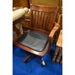 A reproduction stained frame office arm chair
