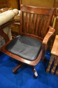 A reproduction stained frame office arm chair