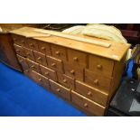 A modern pine merchants style chest/shop fitting, approx. Dimensions W168cm H90cm D32cm