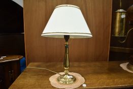 A small brass table lamp.