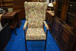 A traditional wing back brocade arm chair.